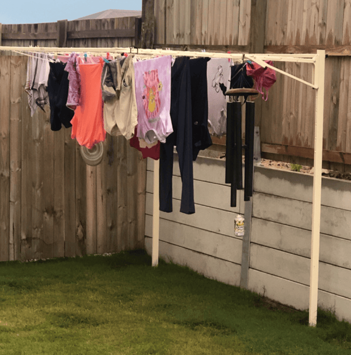 austral standard 28 clothesline ground mounted installed in lawn with washing on the line