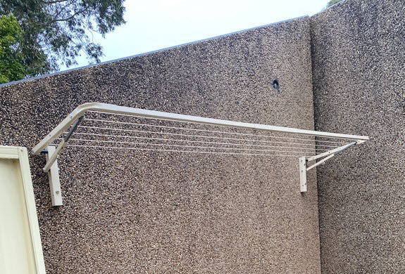 eco 210 clothesline mounted to concrete wall