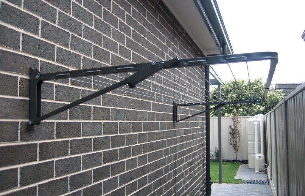 Austral Compact 28 Clothesline Woodland Grey installed on brick wall at side of house