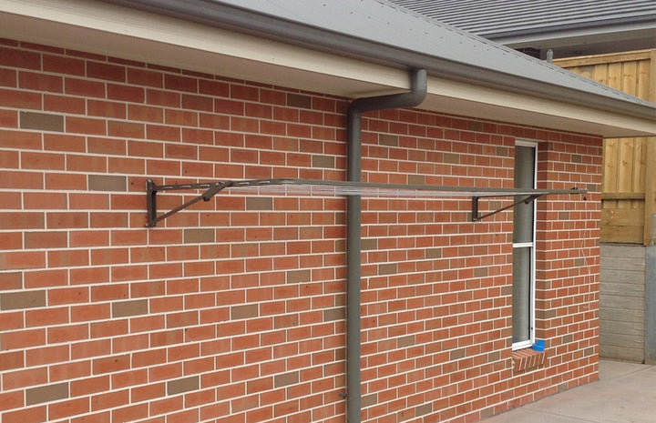 Austral Compact 39 Clothesline Woodland Grey installed on brick wall