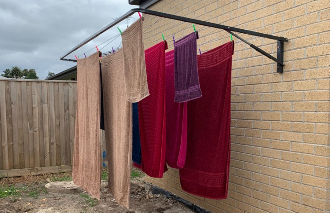 Eco 270 Clothesline installed on a brick wall and in monument colour